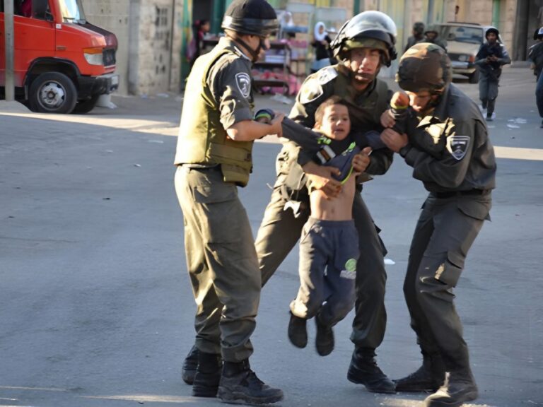 Little crying Palestinian boy dragged in the air by the arms by 3 Israeli officers
